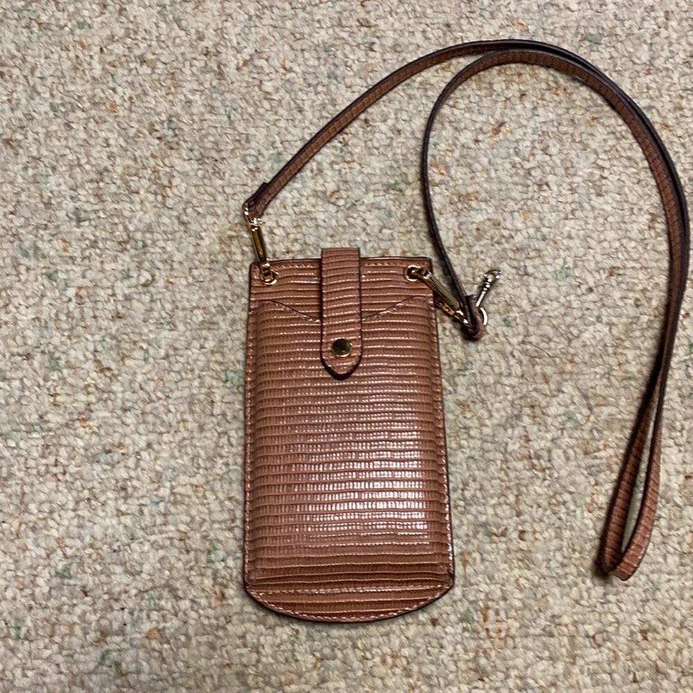 Ladies small purse color dark blush hardware is rose gold no brand name.